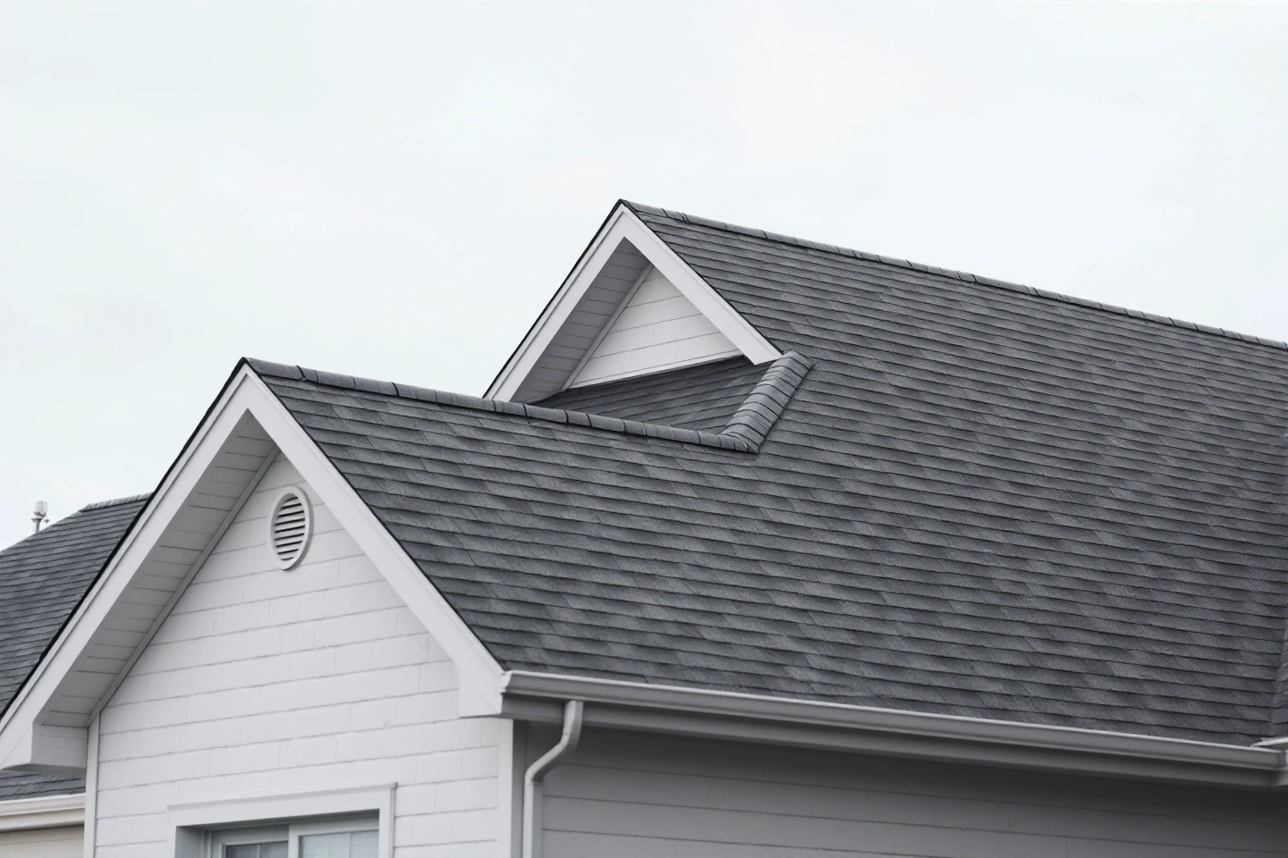 an intact gray shingle roof with two small gables